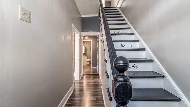 A staircase with a black balustrade and a white wall. - Amazing historic home from 1860!  (St Charles)