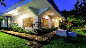 A modern house with a spiral staircase, large windows with metal bars, and a well-maintained garden. - BIG! 3BR Home Fully Equipped, Pool, Gardens & WiFi (El Cedral)