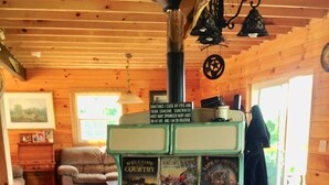 A vintage green stove with multiple burners and a sign above it. - Spectacular Views, Swimming Pool, Hot Tub, Real Log Fires, Mountain Getaway (Rileyville)