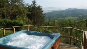 A hot tub on a wooden deck with a view of mountains. - Spectacular Views, Swimming Pool, Hot Tub, Real Log Fires, Mountain Getaway (Rileyville)