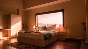 A bedroom with a large window, a bed, bedside tables, and a nightstand. - D'Polo Club And Spa Resort, Dharamshala (Dharamshala)