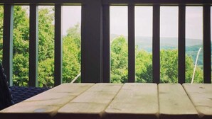 A wooden deck with a view of a forested landscape. - Seven Springs Slope-Side Home, Ski right to the Lift #1  Boomerang Trail. (Champion)
