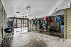 Storage area with a grill and shelving for personal items.