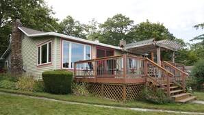 A house with a deck, a staircase, and a chimney. - Beautiful Views, Sunrises, Dog Friendly, Comfortable! (Penn Yan)