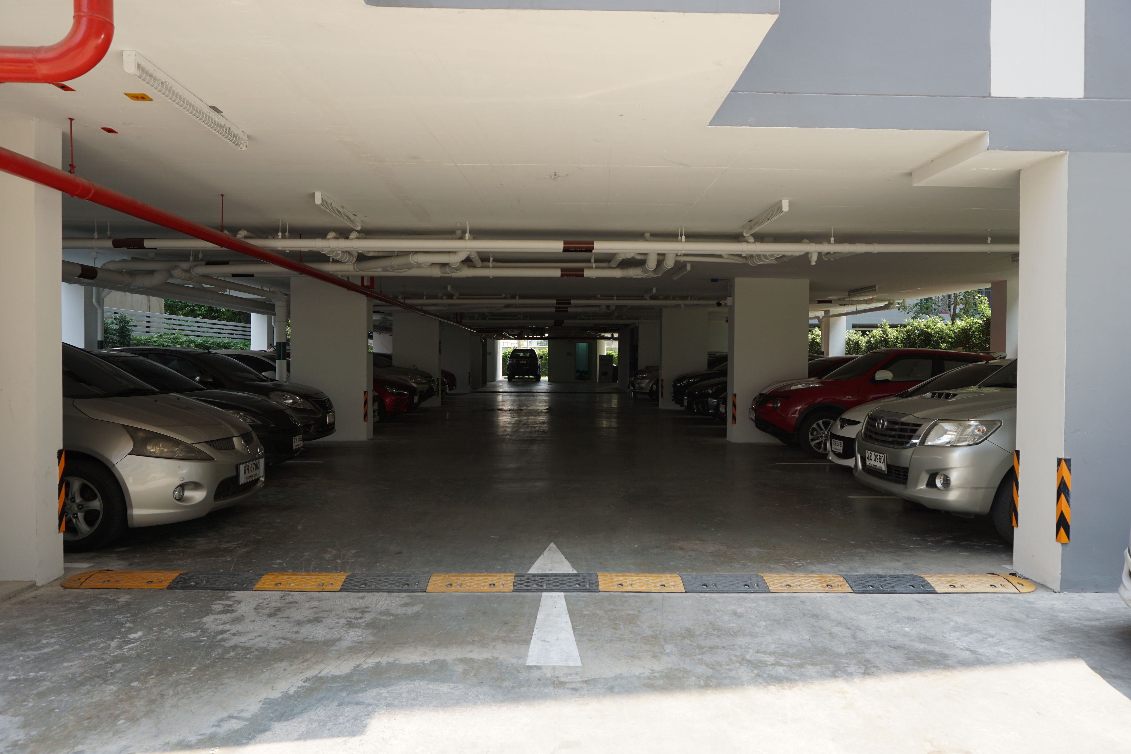 A multi-level parking garage with cars parked on both levels.