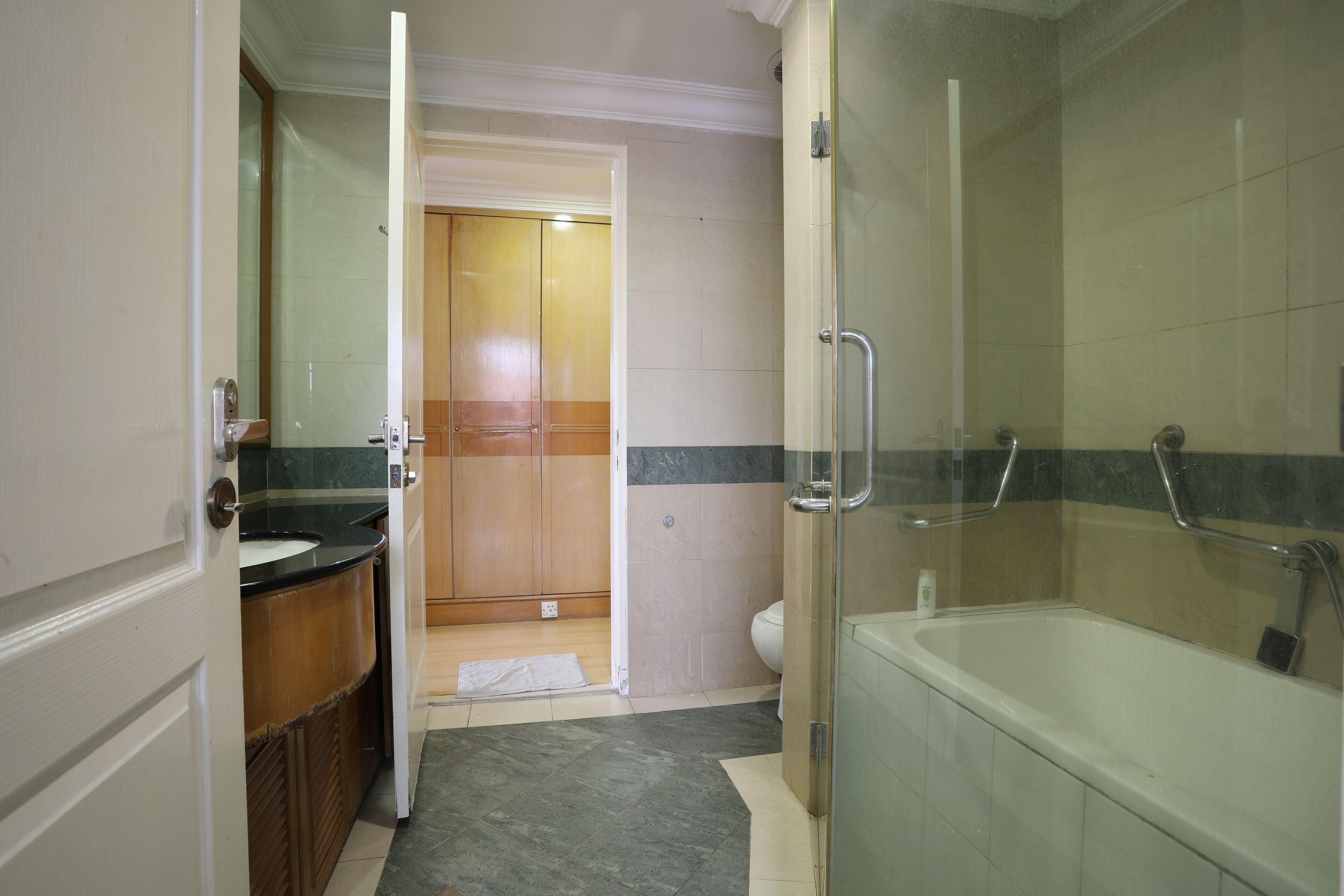 A bathroom with a shower, a bathtub, and a toilet.