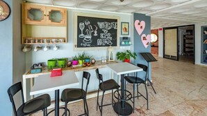 A modern kitchen with a chalkboard wall, bar stools, and a coffee station. - Alibabam Apart Hotel (Kusadasi)