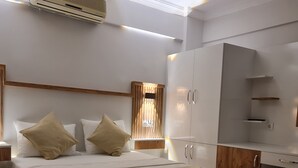 A modern bedroom with a wooden bed frame, white bedding, and a built-in wardrobe with a mirror. - Alibabam Apart Hotel (Kusadasi)