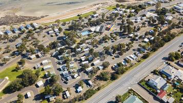 Residents enjoy a natural environment with green spaces and trees, and easy access to the community via main roads and intersecting streets.