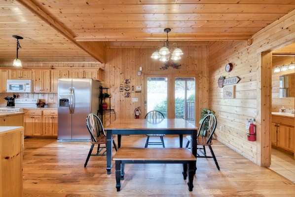 Enjoy family meals and gatherings around the central dining table, complete with four chairs.