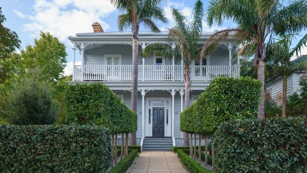 A two-story house with a front porch, a balcony on the second floor, and a front door. - Andelin Guest House (Auckland)