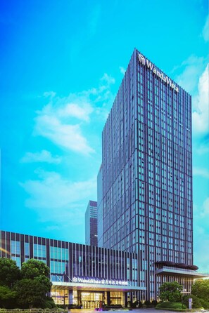 A modern high-rise hotel with a prominent 'WandaVista' sign, featuring a glass facade and a structured, vertical design. - Wanda Vista Changsha (Changsha)