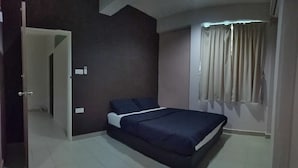A bedroom with a bed, a window with curtains, and a door leading to another room. - HOOD - Hostel (Kota Kinabalu)