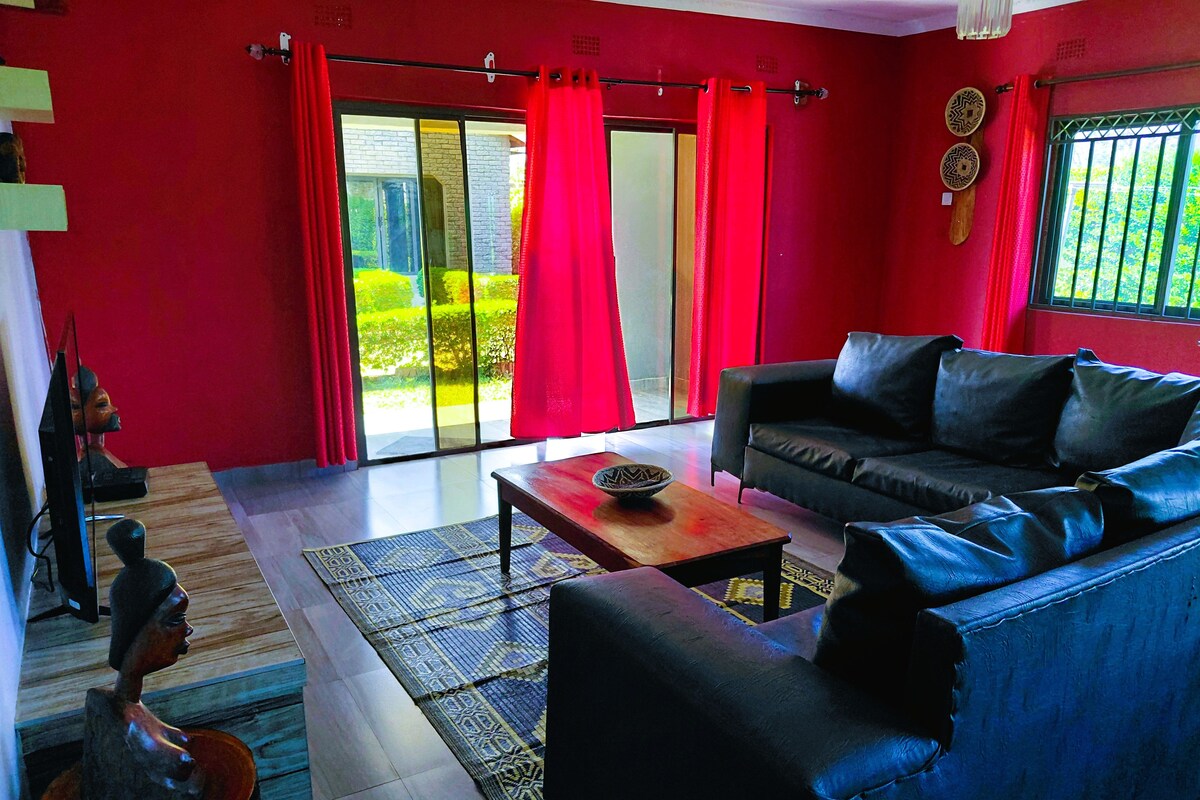 A living room with a sofa, a coffee table, and a television.