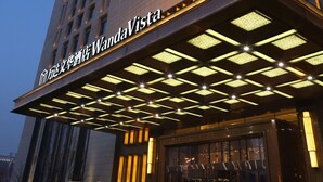 A high-rise hotel with illuminated signage and a modern architectural design.