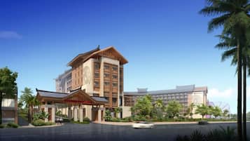 A modern hotel with a traditional architectural style, featuring a large building with multiple floors and a prominent entrance area.