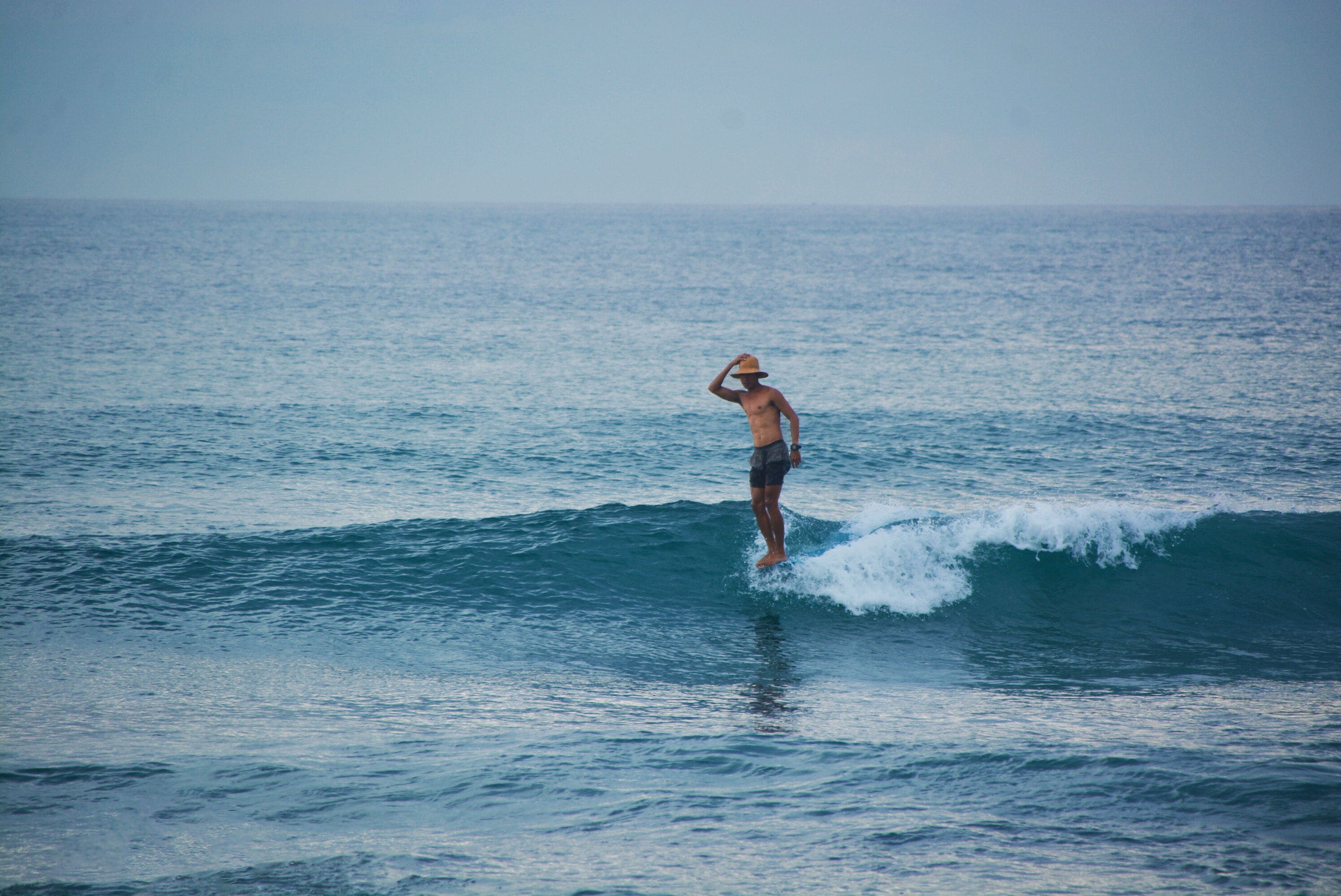 A person surfing on a wave in the ocean.