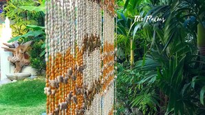 A close-up of a textured wall with a garden view. - The Palms Resort & Bar (San Narciso)