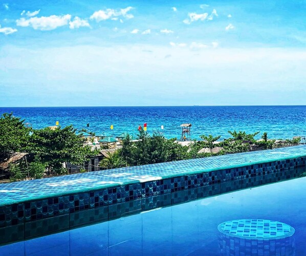 Relax by the oceanfront pool, surrounded by a tranquil atmosphere and breathtaking views.