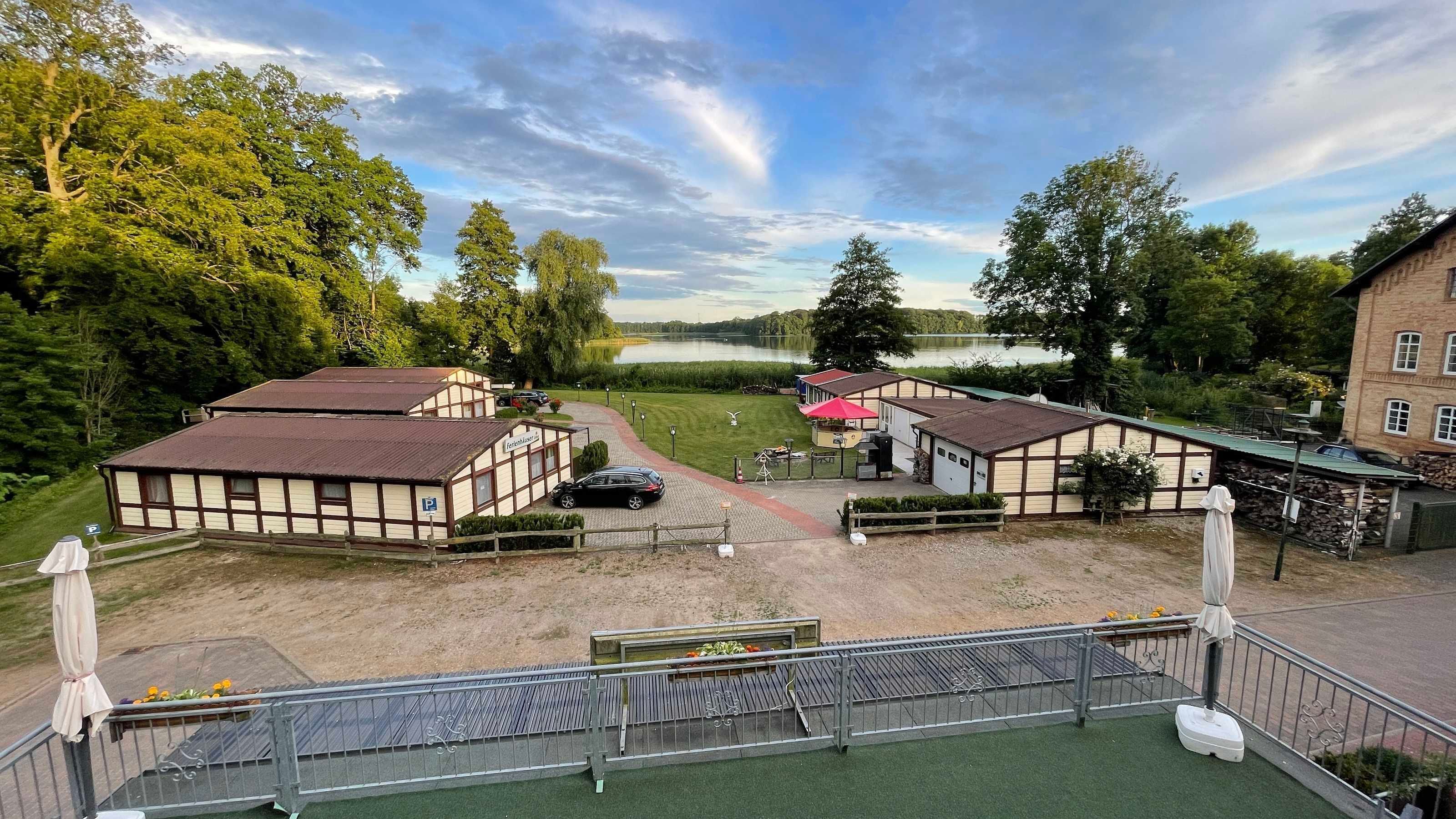 A traditional building with a sign 'Hotel & Restaurant' and a view of a lake.