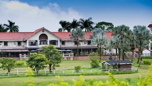 A large building with a red roof, multiple windows, and a central arched entrance. - Shin Kong Chao Feng Ranch And Resort (Fenglin)