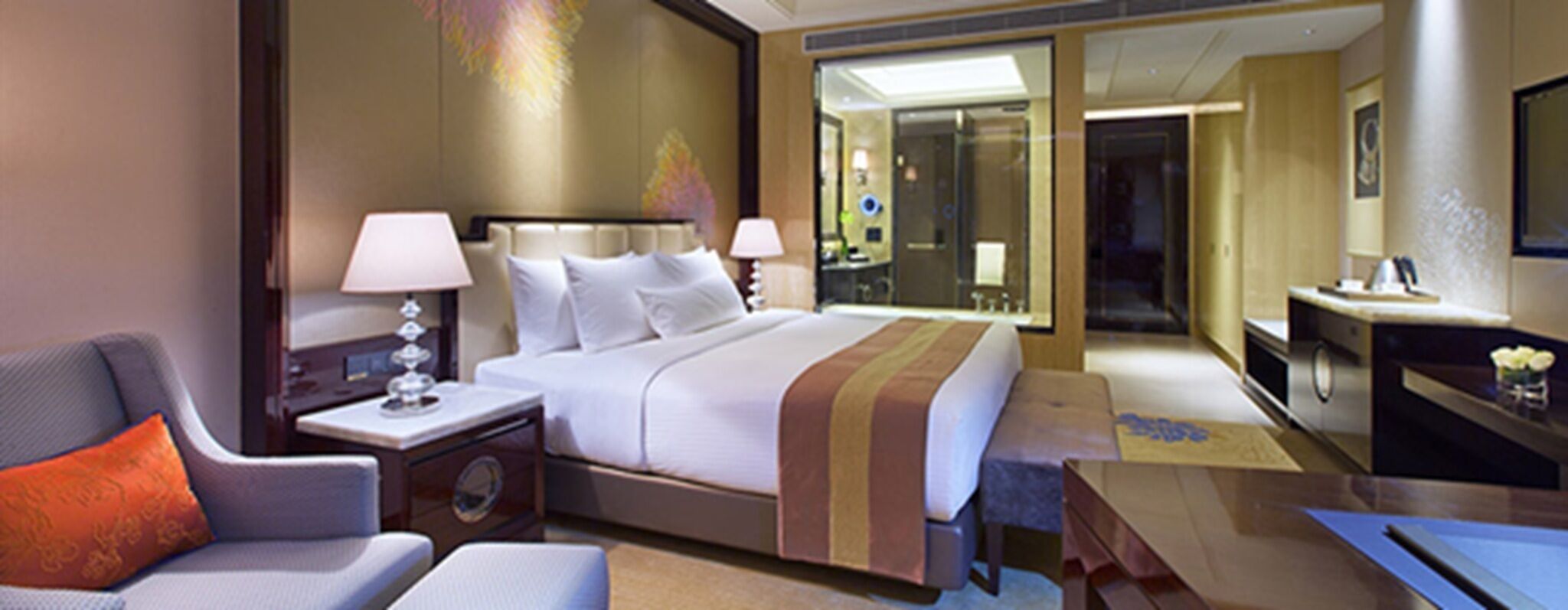 A hotel room with a bed, two bedside tables, a chair, a desk, and a mirror.