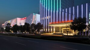 A modern building with vertical light strips and a prominent sign. - Wanda Realm Maanshan (Ma'anshan)
