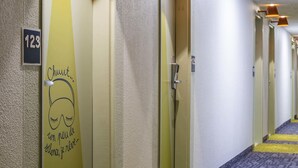 A hotel hallway with doors numbered 123, 47, and 49.