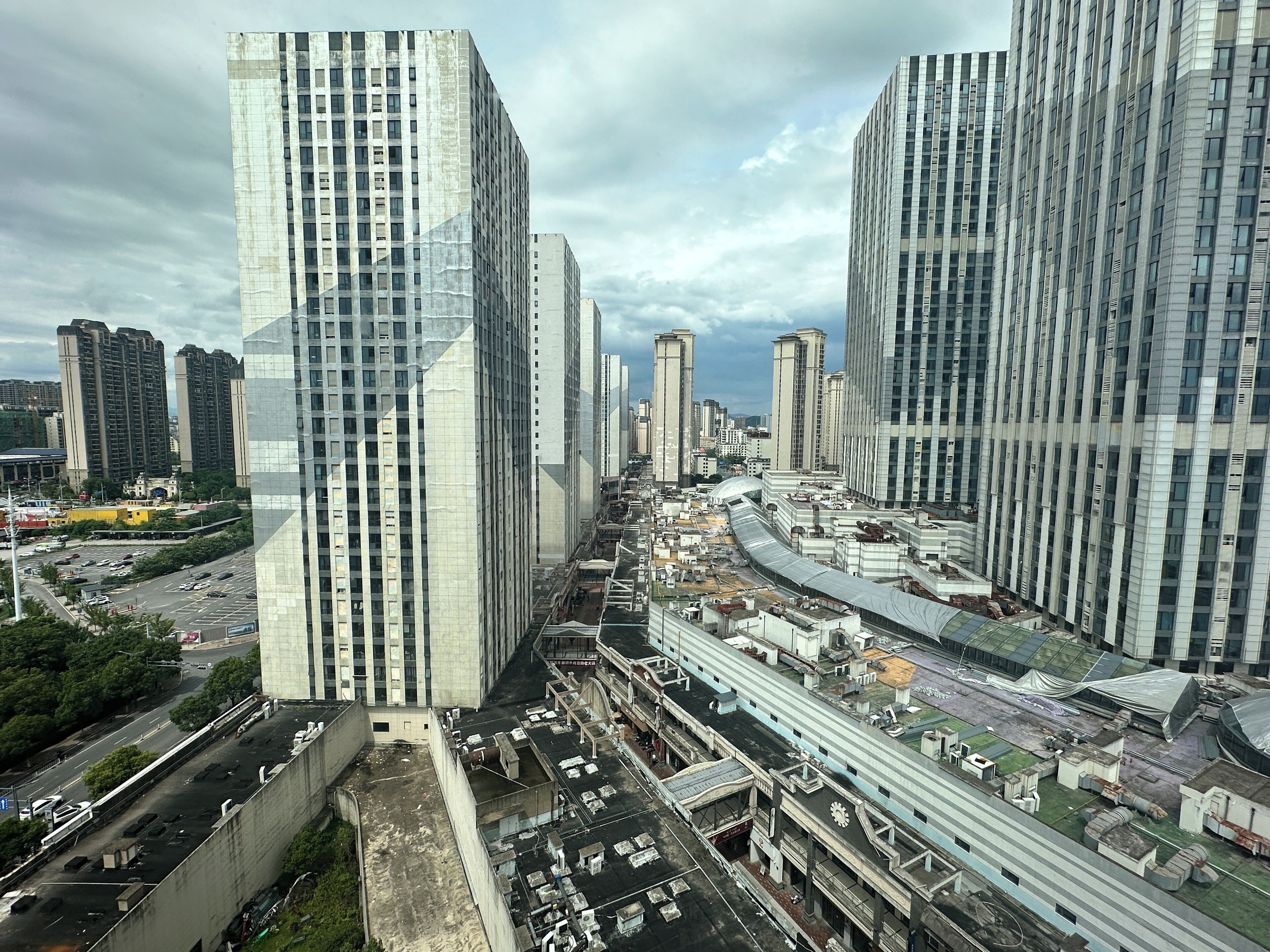 A high-rise urban area with modern architecture, including tall buildings and a complex network of roads and infrastructure.