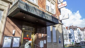 A hotel with a classic facade, a prominent sign, and a well-maintained entrance. - sevenDays Hotel BoardingHouse (Karlsruhe)