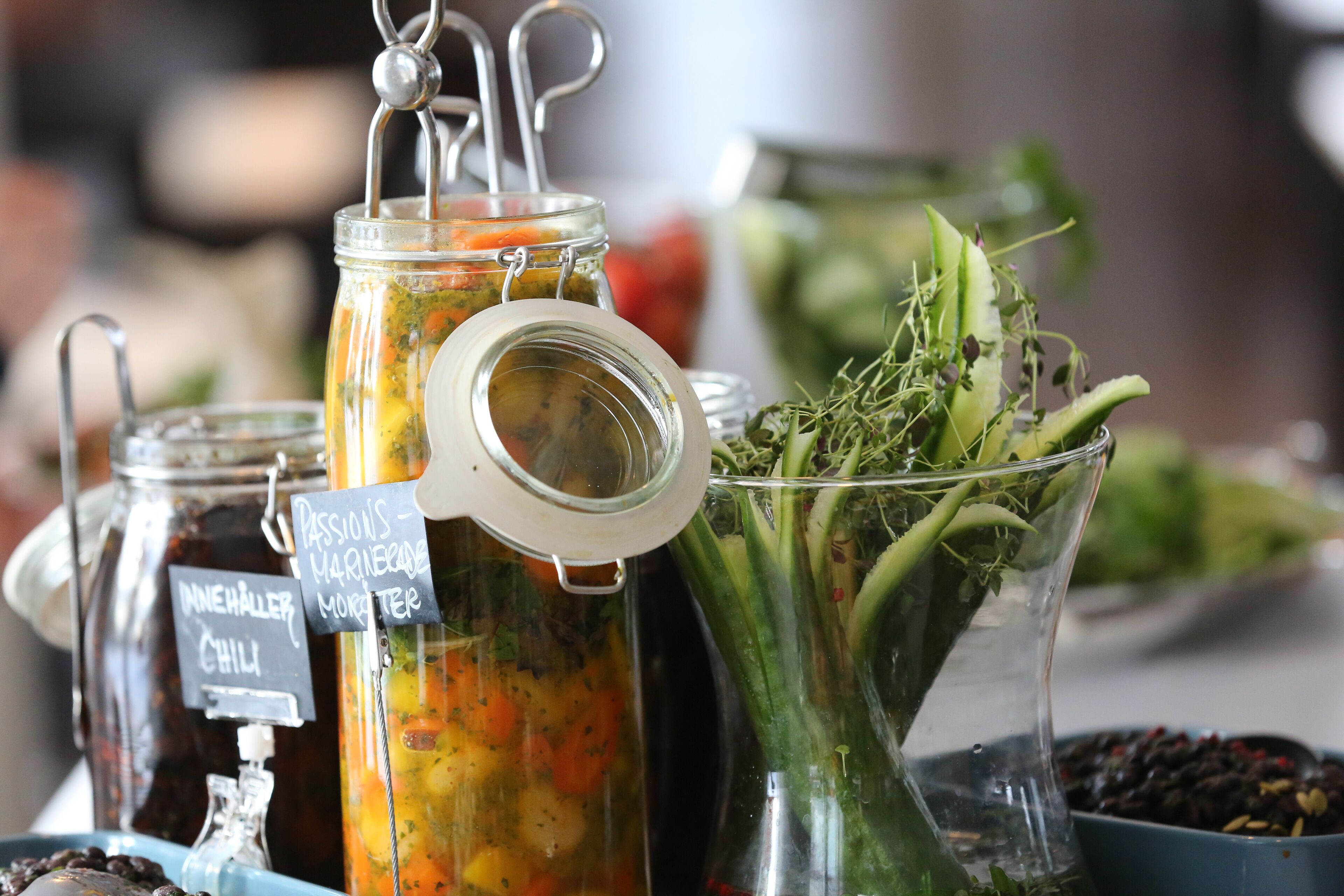 A variety of food items and condiments, including jars labeled with names like "Passions Marinade" and "Chili."