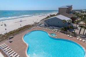 A swimming pool with a view of the beach and ocean.