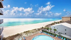 A beachfront hotel with a swimming pool, beach view, and a building with a flat roof. - TIDEWATER 4th FLOOR - SKIP ELEVATORS! No Windows on Hallway, walk to Pier Park! (Panama City Beach)