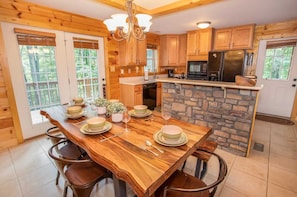 Enjoy meals in this inviting kitchen with a dining table, refrigerator, microwave, and oven.