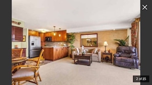 A spacious living area with a kitchen, a dining set, and a leather sofa. - KJ’s Place, in the heart of the city. (Kailua-Kona)