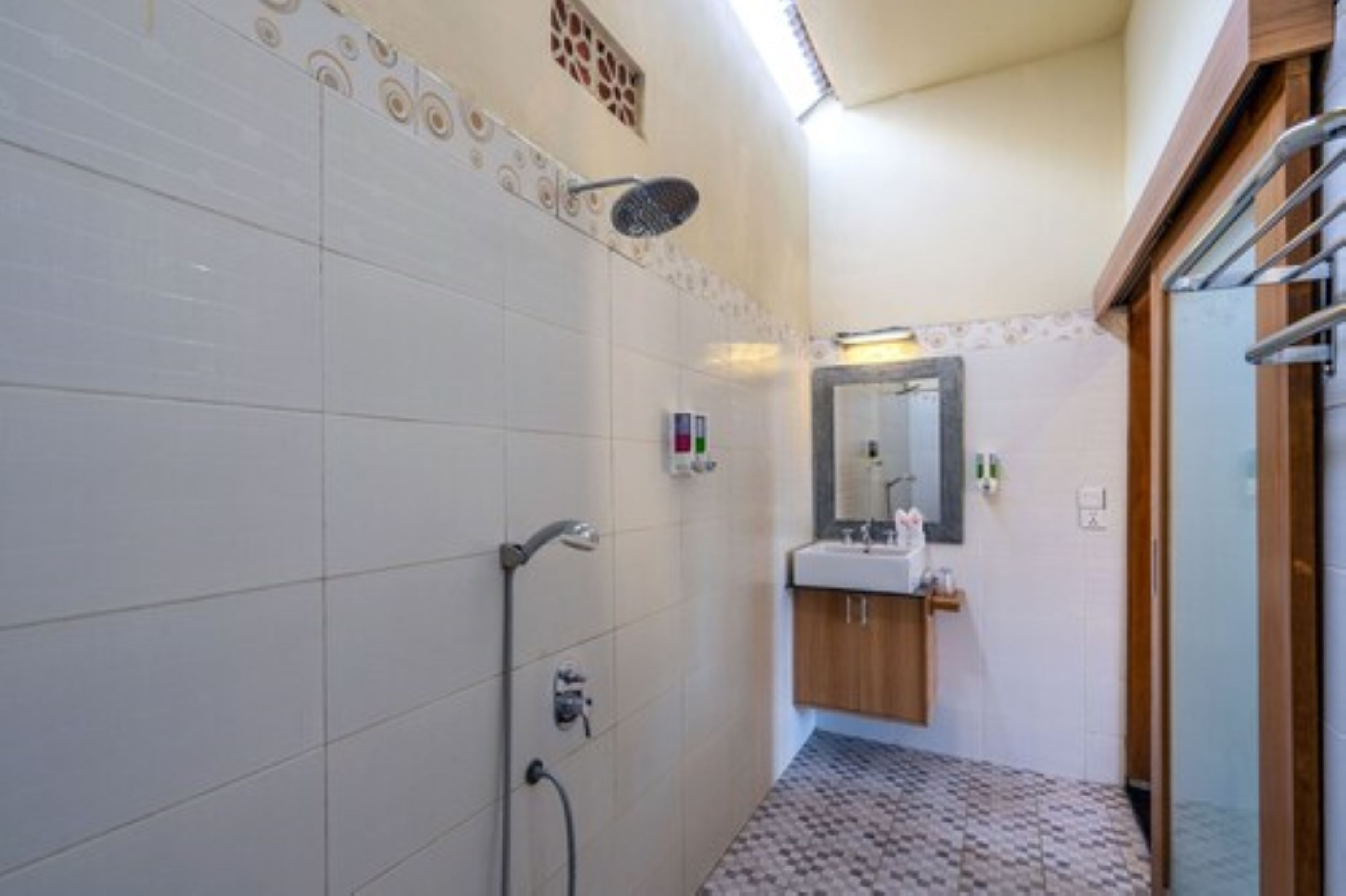A bathroom with a shower, toilet, and sink.