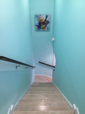 A staircase with light blue walls and wooden steps.