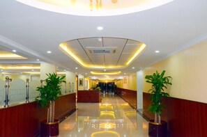 A hotel lobby with a polished floor, a reception desk, and potted plants. - Jubail Inn (Al Jubail)