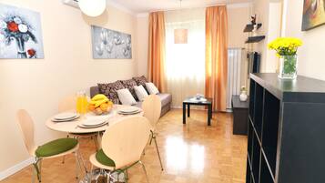 Apartment, City View | Living area | Flat-screen TV
