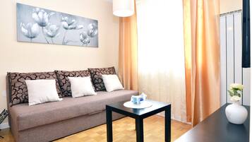 Apartment, City View | Living area | Flat-screen TV