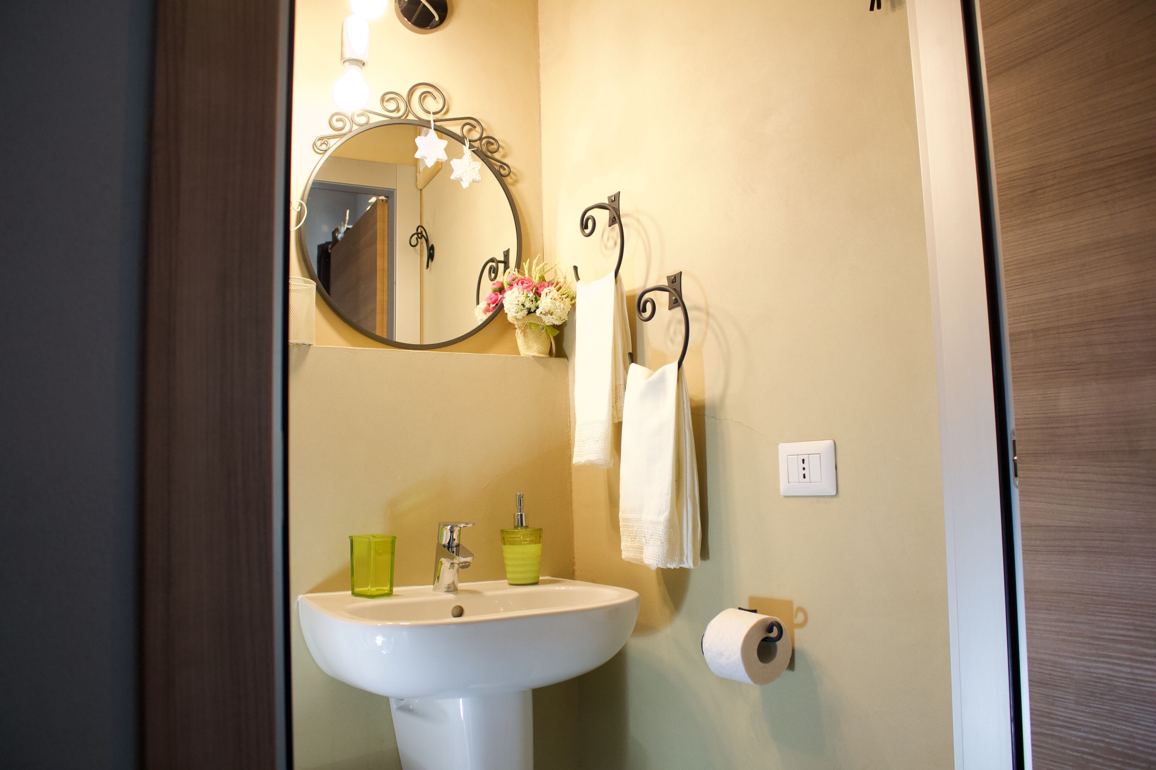 A bathroom with a sink, mirror, and towel rack.