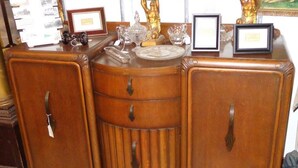 A wooden cabinet with three drawers and two doors, featuring metal handles. - Old Winterport Commercial House (Winterport)