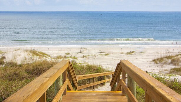 A wooden boardwalk leading to a sandy beach with the ocean in the background. - **Newly Remodeled 3/2 Oceanfront ~ 3 King Beds!** (Saint Augustine)