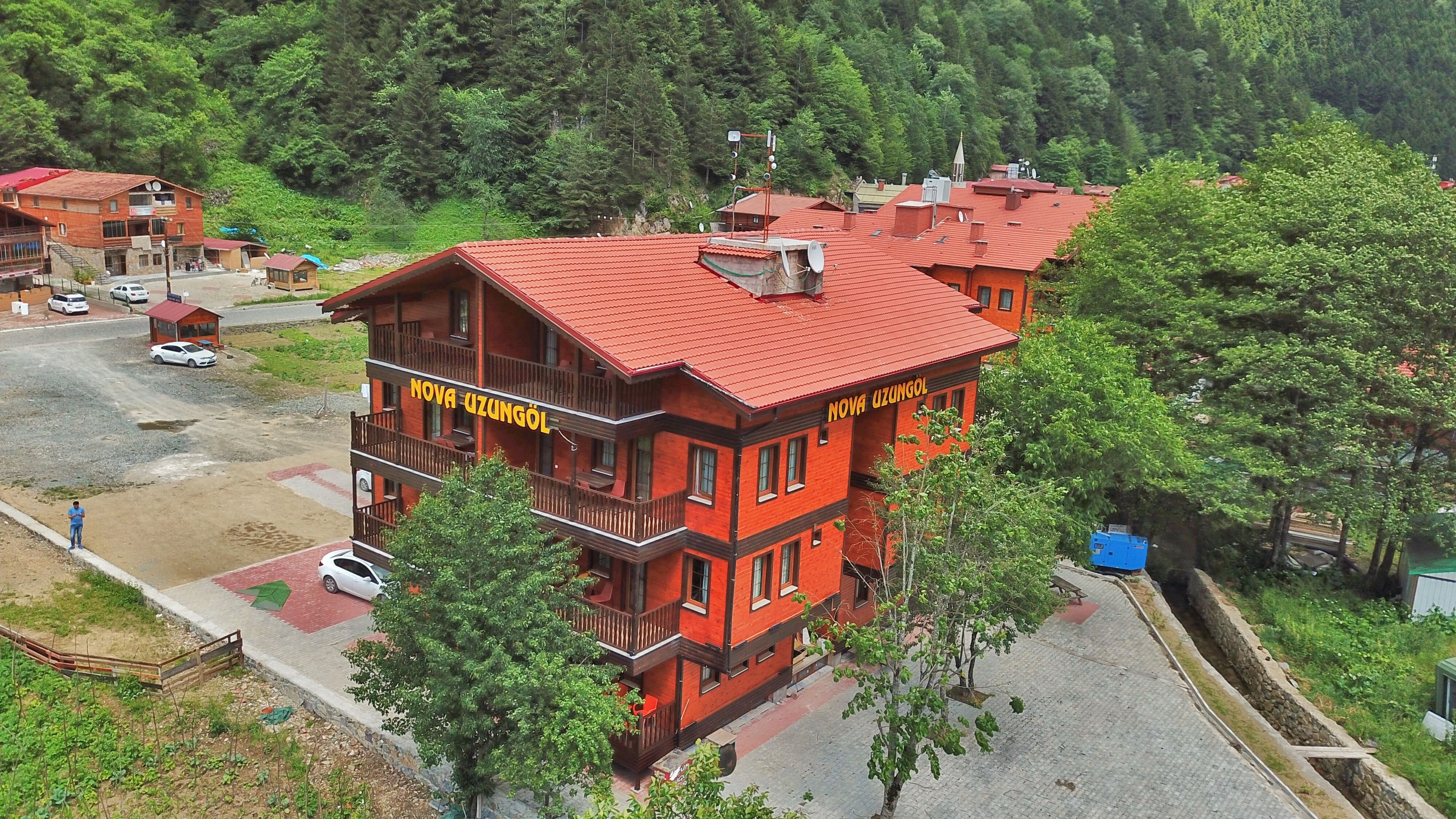 A multi-story building with balconies, labeled "NOVA UZUNGOL."