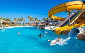 A water park with a large pool, slides, and palm trees. - Sentido Caribbean World Soma Bay - All inclusive (Soma Bay)