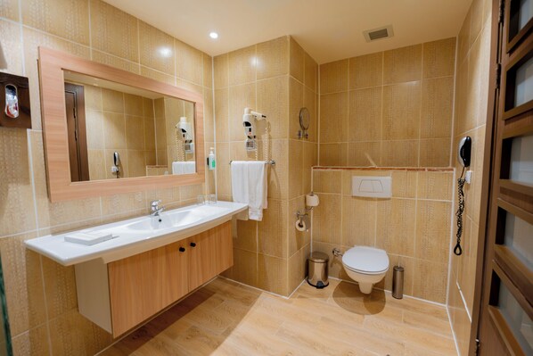 A modern bathroom with a sink, mirror, and toilet. - Sentido Caribbean World Soma Bay - All inclusive (Soma Bay)