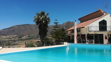 Een seizoensgebonden buitenzwembad, parasols voor strand/zwembad
