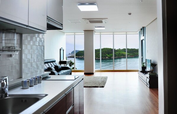 Family Studio Suite | Living area | 42-inch flat-screen TV with cable channels, TV, heated floors