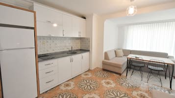 Studio Suite, 1 Queen Bed with Sofa bed, Kitchen, City View | Living area | LCD TV
