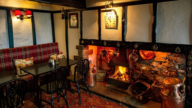 A cozy pub with a wooden interior, a fireplace, and traditional decor. - The Barrel Inn (Hope Valley)